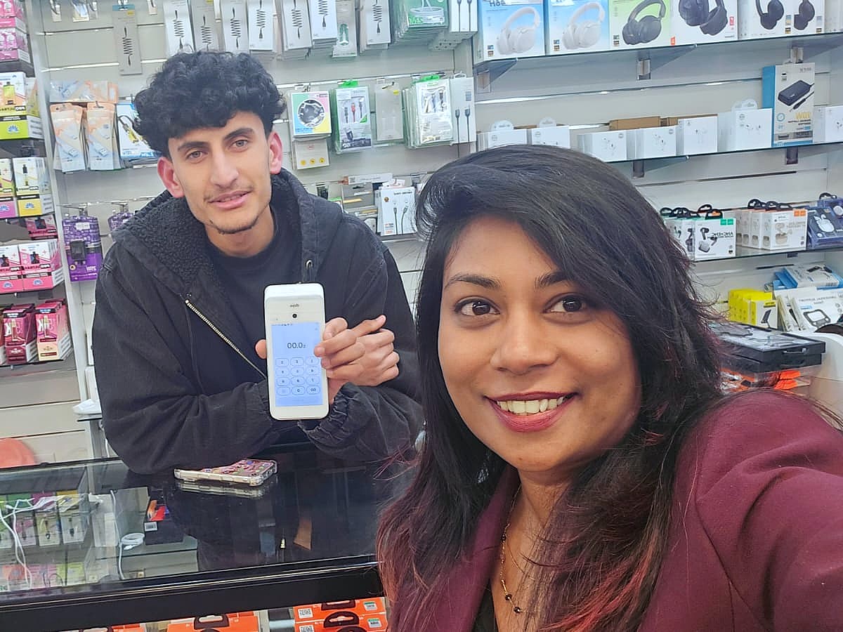 Happy with a shopkeeper, new card terminal in hand